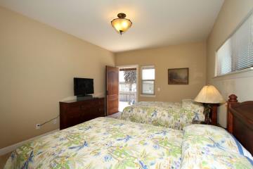 The upstairs bedroom includes a television with DVD and VHS player.