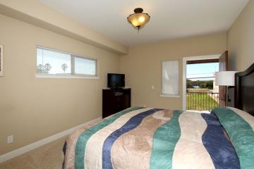 The upstairs Master includes a comfortable California King bed and balcony access.
